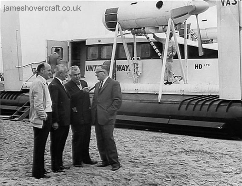First-day certificates and trials of the VA-3 hovercraft - A group of officials including Mr. Harry Parry (in white) greet the crew of VA3-001 upon its arrival at Rhyl in 1962 (Nick Gurney).