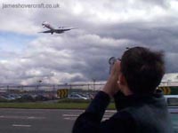 About me - Me taking video of a MD-87 SAS airplane coming into land at Heathrow Airport, 2001 (James Rowson).